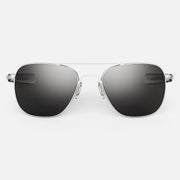 Sunglasses with silver frame and dark lenses on a white background