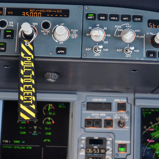 Pull to Eject Aviation keychain hanging off instrument panel