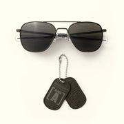 Class A Aviator - Military Olive & American Gray Aviator Sunglasses with a pair of dog tags on a white background